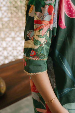 Close-up of a person wearing a colorful floral dress with a blurred background