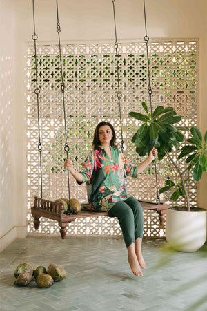 Woman sitting on a wooden swing in a room with decorative elements and plants.

